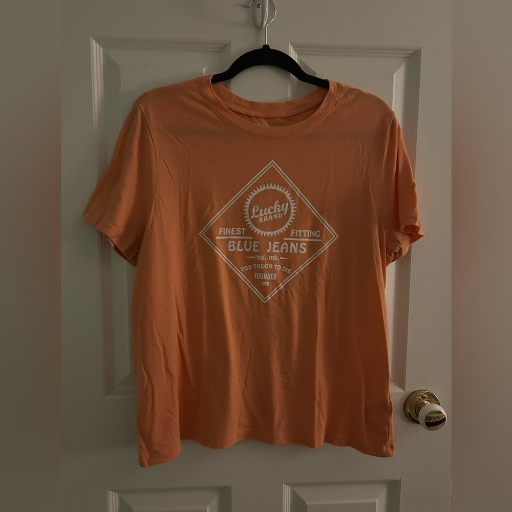 Lucky Brand Ladies “Finest Fitting Blue Jeans” Ladies Orange Graphic T-Shirt